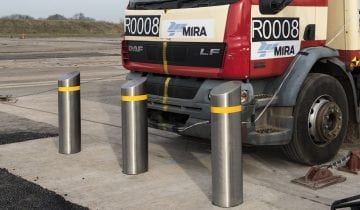 multiple truckstopper bollards sydney against a red truck